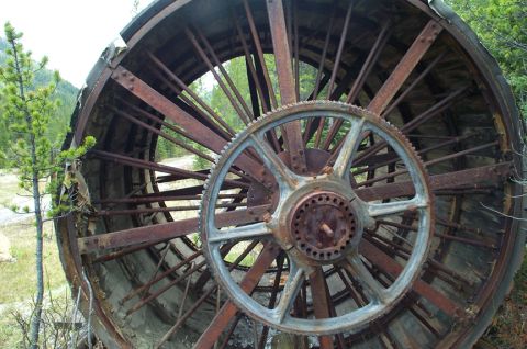 1996 Ford Bronco - This heavily rusted industrial wheel, possibly from old mining equipment, sits abandoned outdoors.