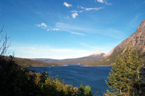 1996 Ford Bronco - Wide view of a lake surrounded by mountains and trees on a clear day.