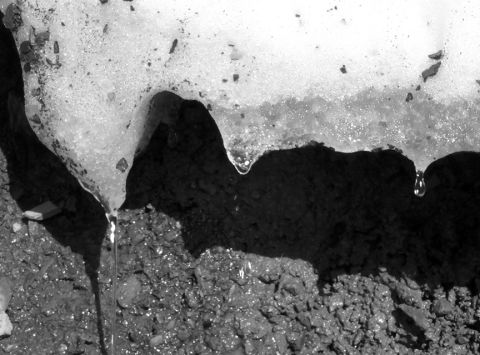 1996 Ford Bronco - Water drips from melting snow and ice onto a rough, rocky surface, as seen in this close-up scene.