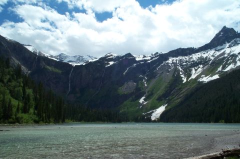 1996 Ford Bronco - A vast mountain landscape unfolds with a tranquil lake reflecting the dramatic sky and peaks.