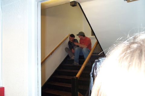 1996 Ford Bronco - Two men converse while seated on the steps of an indoor staircase.
