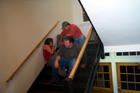 1996 Ford Bronco - Three people are sitting on a staircase, with one person looking down.