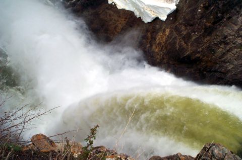 1996 Ford Bronco - A large waterfall plunges down a rocky cliff face, creating a significant amount of spray and turbulent water.
