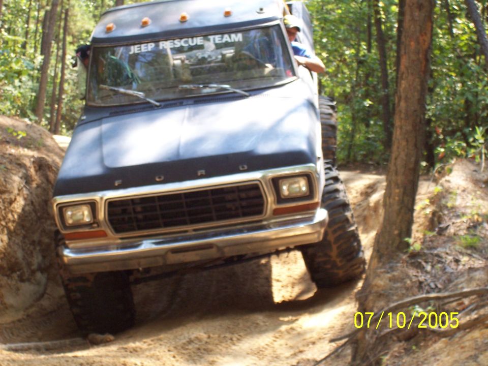 Ford truck with "JEEP RESCUE TEAM" on windshield going off-road