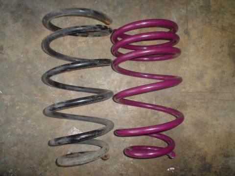 1993 Ford Taurus - Two automotive coil springs, one black and one purple, are shown for comparison.