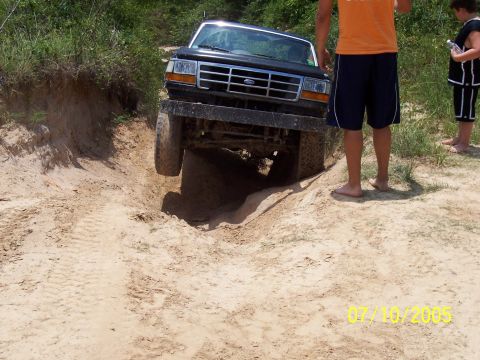 1987 Ford Bronco - 1987 Ford Bronco navigating a challenging sandy terrain.