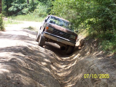 1987 Ford Bronco - This 1987 Ford Bronco tackles a challenging off-road trail with steep inclines and deep ruts.
