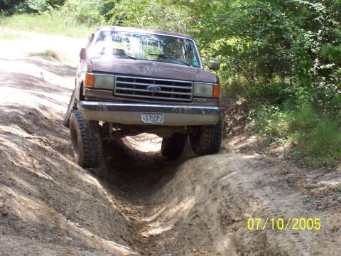1987 Ford Bronco - This 1987 Ford Bronco is tackling a challenging off-road trail.