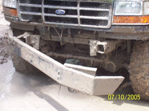 1987 Ford Bronco - This Ford truck's front end is covered in mud, suggesting it is stuck in a muddy area.
