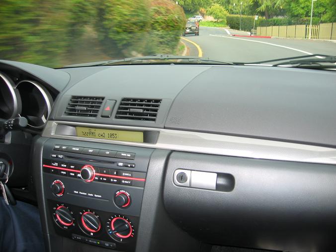Interior dashboard with radio display showing 122.1 FM CH2 105.3