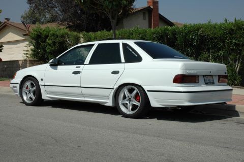 1993 Ford Taurus - This white sedan's body style suggests a model year around 1992, not matching the registry's claim of 1993.