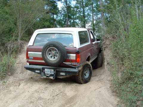 1993 Ford Bronco - This 1993 Ford Bronco is navigating a challenging dirt trail with steep inclines.