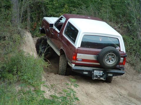 1993 Ford Bronco - This 1993 Ford Bronco navigates a steep, sandy incline with its tires digging into the loose soil.