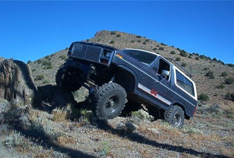 1986 Ford Bronco - This 1986 Ford Bronco is tackling a steep, rocky incline off-road.