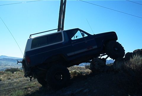 1986 Ford Bronco - This 1986 Ford Bronco is navigating a steep, rocky incline off-road.
