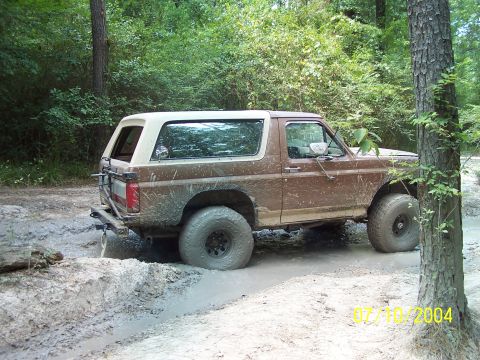 1987 Ford Bronco - This 1987 Ford Bronco is shown off-road, stuck in a muddy rut.