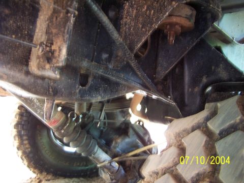 1987 Ford Bronco - A close-up view of the undercarriage reveals the vehicle's suspension system and a tire, with a date stamp of 07/10/2004.