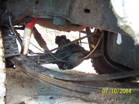 1987 Ford Bronco - Close-up of rear axle and suspension parts on a vehicle.