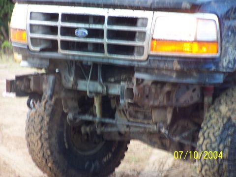 1987 Ford Bronco - Close-up of a Ford truck's front end, the grille and bumper. The date 07/10/2004 is visible.