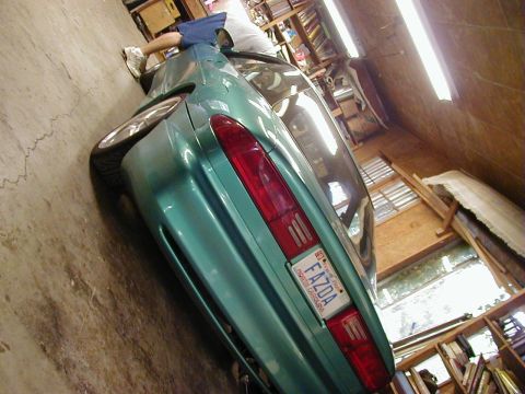 1994 Ford Probe - Rear view of a 1994 Ford Probe parked inside a garage with shelves and lights visible.