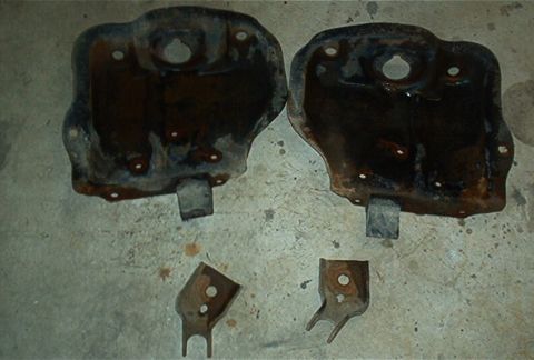 1986 Ford Bronco - Two rusty metal plates and two smaller brackets are shown on a concrete floor. The registry claims this is a 1986 Ford Bronco, but this is…