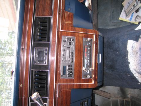 1991 Ford LTD Crown Victoria - The dashboard features wood grain accents, air vents, and an older model car stereo system.