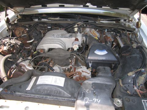 1991 Ford LTD Crown Victoria - Engine bay view showing engine components, wiring, and a handwritten date of 12-94.