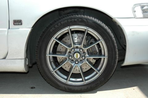1993 Ford Taurus - Custom wheel and brake setup on a white vehicle, BBS rims and Cobra calipers.
