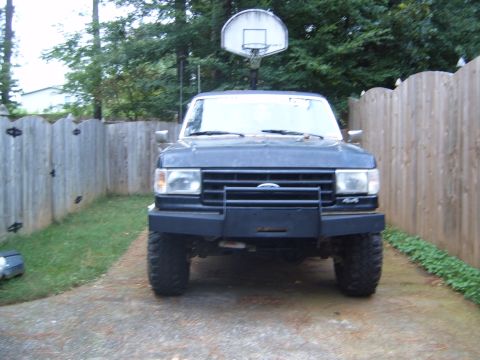 1988 Ford Bronco - This 1988 Ford Bronco is shown from the front, a brush guard and 4x4 badging.
