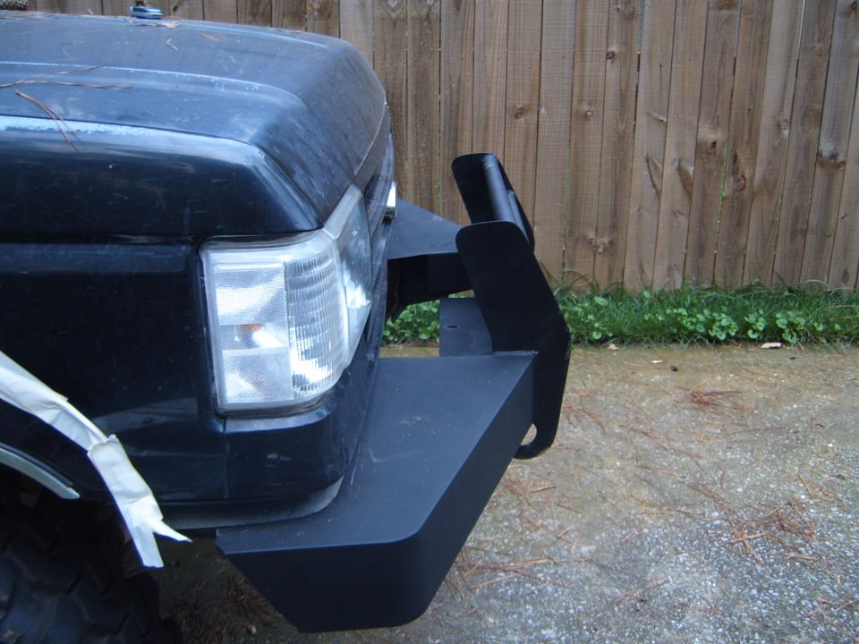 Custom flat-black fabricated front bumper fitted to the corner of a dark Ford Bronco