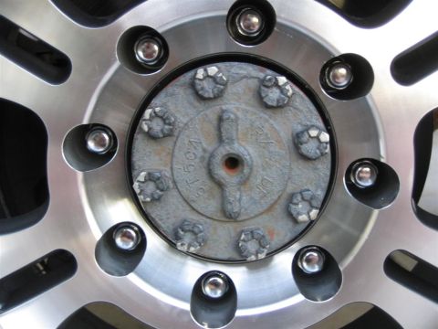 1999 Ford F-250 - Wheel hub detail with lug nuts visible, part of a custom wheel.
