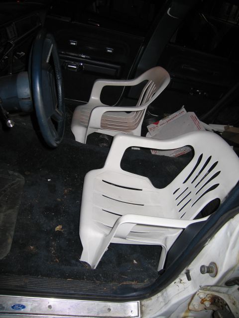 1991 Ford LTD Crown Victoria - Interior view of a car, showing two plastic chairs in place of the front seats.