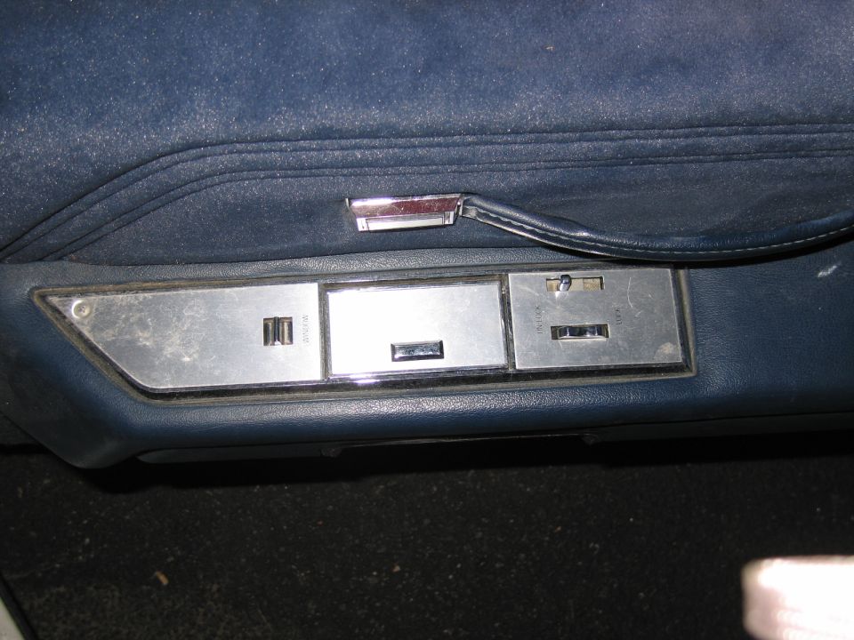 Blue interior door panel with power window and lock controls