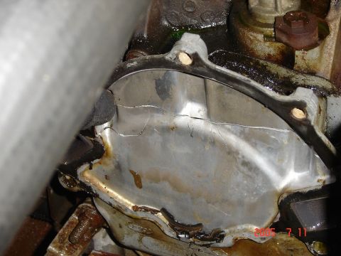 1993 Ford Bronco - Close-up of a damaged engine part, likely a water pump housing, showing significant cracks.