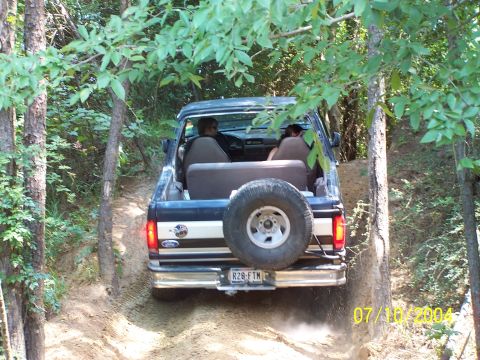 1987 Ford Bronco - This 1987 Ford Bronco is navigating a wooded off-road trail.