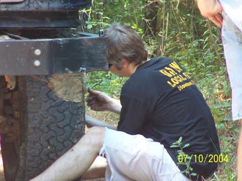 1987 Ford Bronco - A person is seen working on the frame of a vehicle, with a date stamp indicating the photo was taken on July 10, 2004.