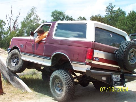 1987 Ford Bronco - This Ford Bronco appears to be from the 1980s, not a 1987 model, as it is driving over an obstacle.
