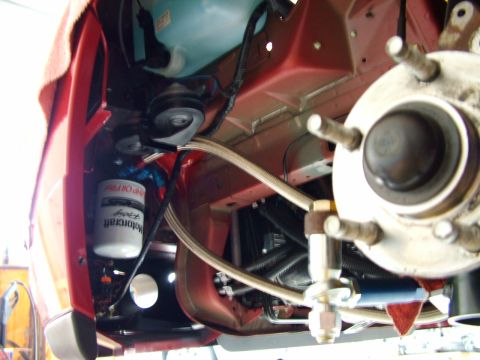 2003 Ford Mustang - Motorcraft oil filter and brake components visible in the engine bay of a vehicle.