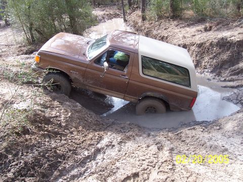 1987 Ford Bronco - This 1987 Ford Bronco is navigating a challenging muddy trail.