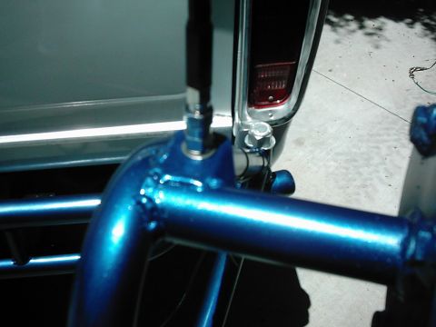 1978 Ford Bronco - Close-up of the rear of a 1978 Ford Bronco, showing a blue roll cage attached near the taillight assembly.