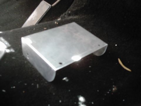 1978 Ford Bronco - A metal bracket is visible on the floor of a vehicle, near the gas pedal.