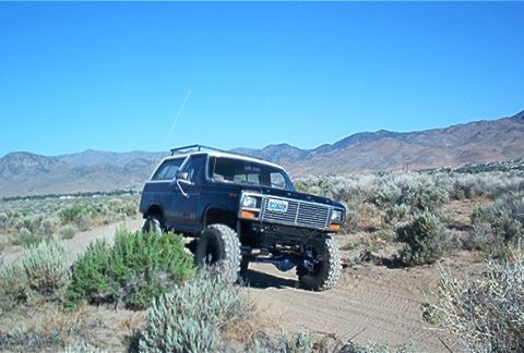 1986 Ford Bronco - This 1986 Ford Bronco is shown navigating a dusty trail in a dry, mountainous region.