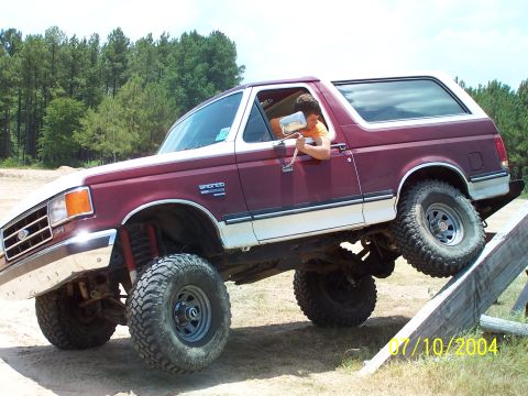 1987 Ford Bronco - This Ford Bronco is navigating an off-road course with a driver inside.