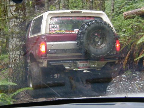 1994 Ford Explorer - This 1992 Ford Bronco is navigating a wooded trail with a spare tire mounted on the rear.