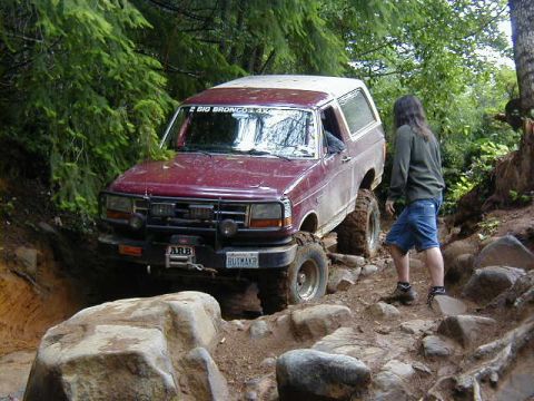 1994 Ford Explorer - This 1994 Ford Bronco is tackling a challenging off-road course, demonstrating its capabilities on rough terrain.