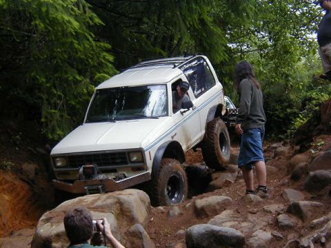 1994 Ford Explorer - This 1980s Ford Bronco navigates a challenging rocky terrain on an off-road trail.