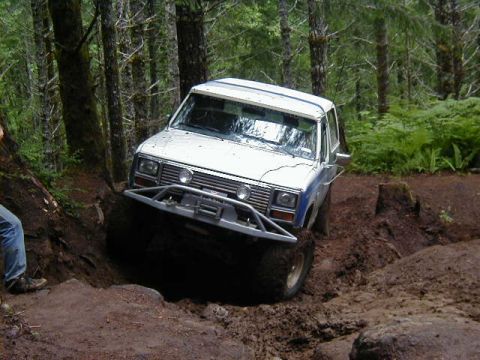 1994 Ford Explorer - This SUV is tackling a challenging muddy trail, demonstrating its off-road capabilities.