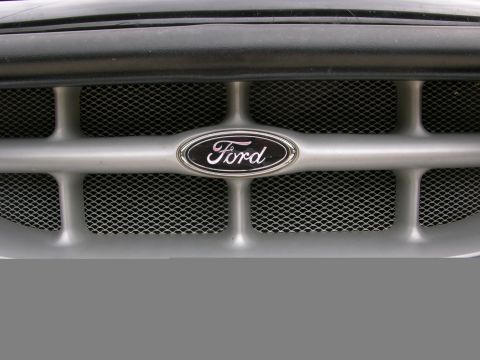 1995 Ford Explorer - The front grille of a 1995 Ford Explorer features the iconic Ford oval emblem.