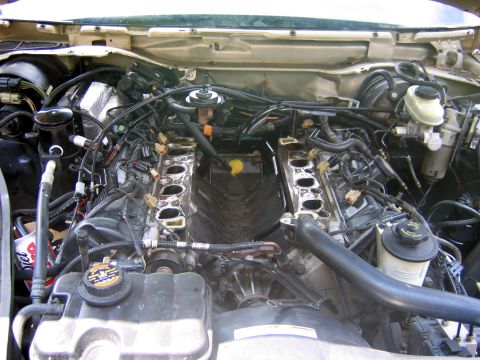 2000 Ford Crown Victoria - After the stock manifold was removed. Note the different route of the PI coolant tube.