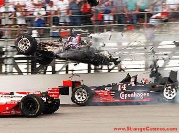 1968 Ford Mustang - A dramatic IndyCar crash unfolds on the track, with debris flying and one car flipping into the air.